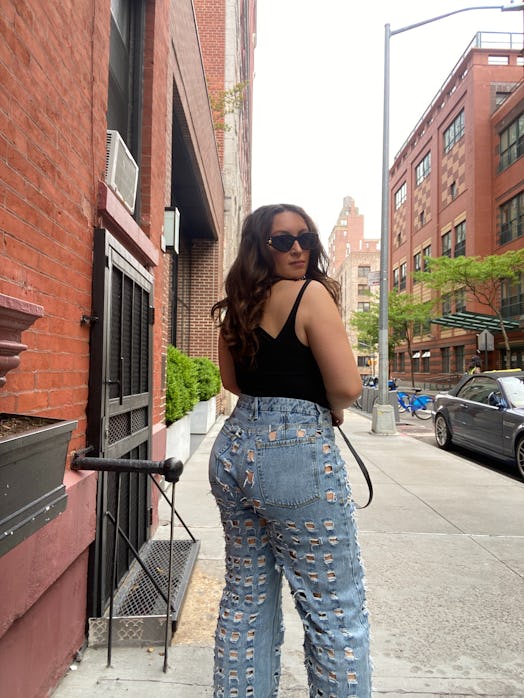 bella gerard wears good american’s good 90s laser butt cut-out jeans in indigo wash