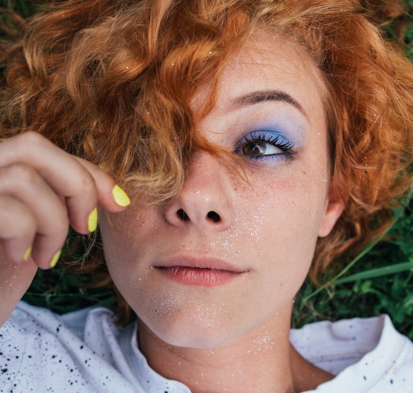 a woman looking at her hair without a itchy, dry scalp, using products to get rid of itchy, dry scal...
