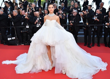 Olivia Culpo wearing a large white gown at the Cannes Film Festival
