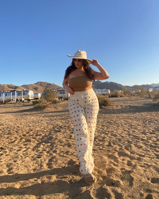 bella gerard wears good american cut-out jeans in white and tevas sandals