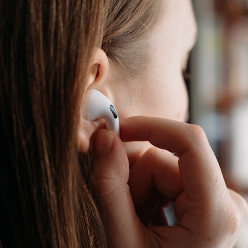 A person placing an AirPod Pro into their ear - Best AirPods Pro Ear Tips