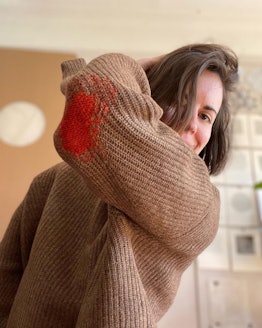 sweater with darning on elbow from repair shop