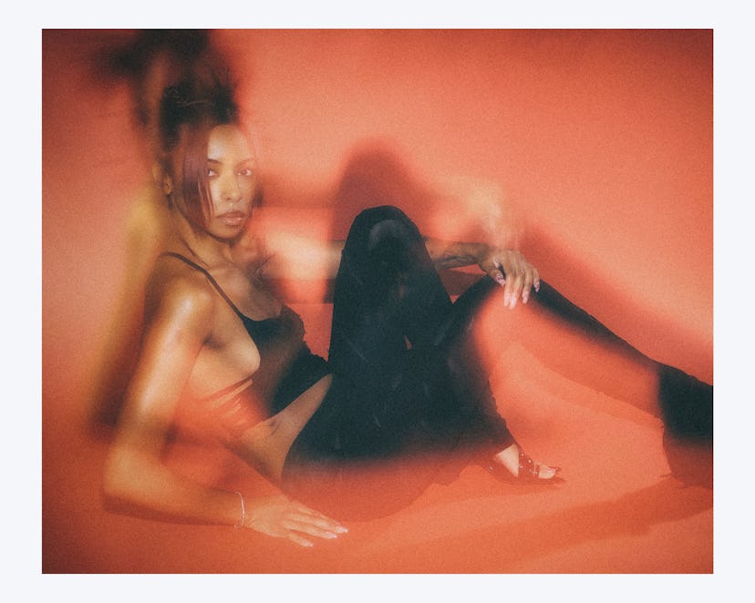 Ravyn Lenae posing in a black outfit
