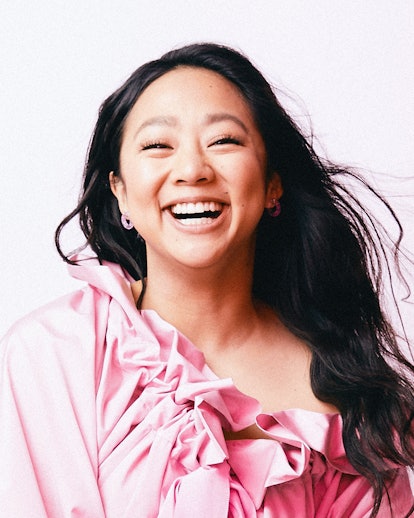 Stephanie Hsu wearing pink ruffled top and smiling