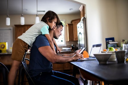 a man and his son sit at their computer