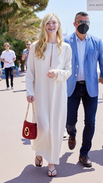 Elle Fanning wearing a white caftan in Cannes