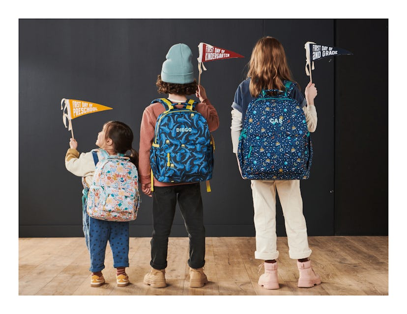 Kids modeling the large, medium, and small backpack in Crate and Barrel's new line