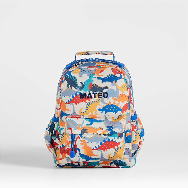 Colorful dinosaurs on cream-colored backpack from Crate and Kids