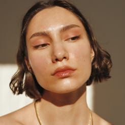 A short-haired brunette with sunscreen on her face