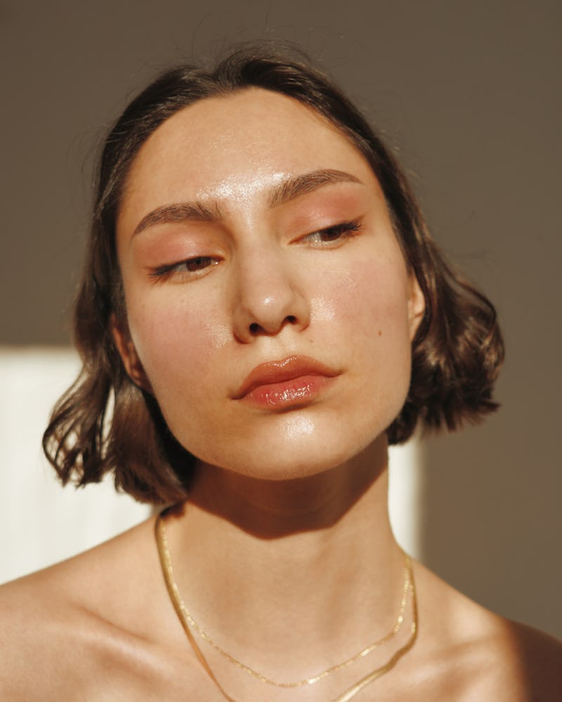 A short-haired brunette with sunscreen on her face