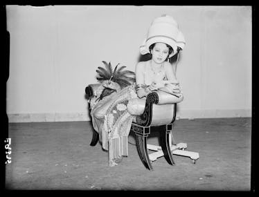 A woman under a round blowdryer