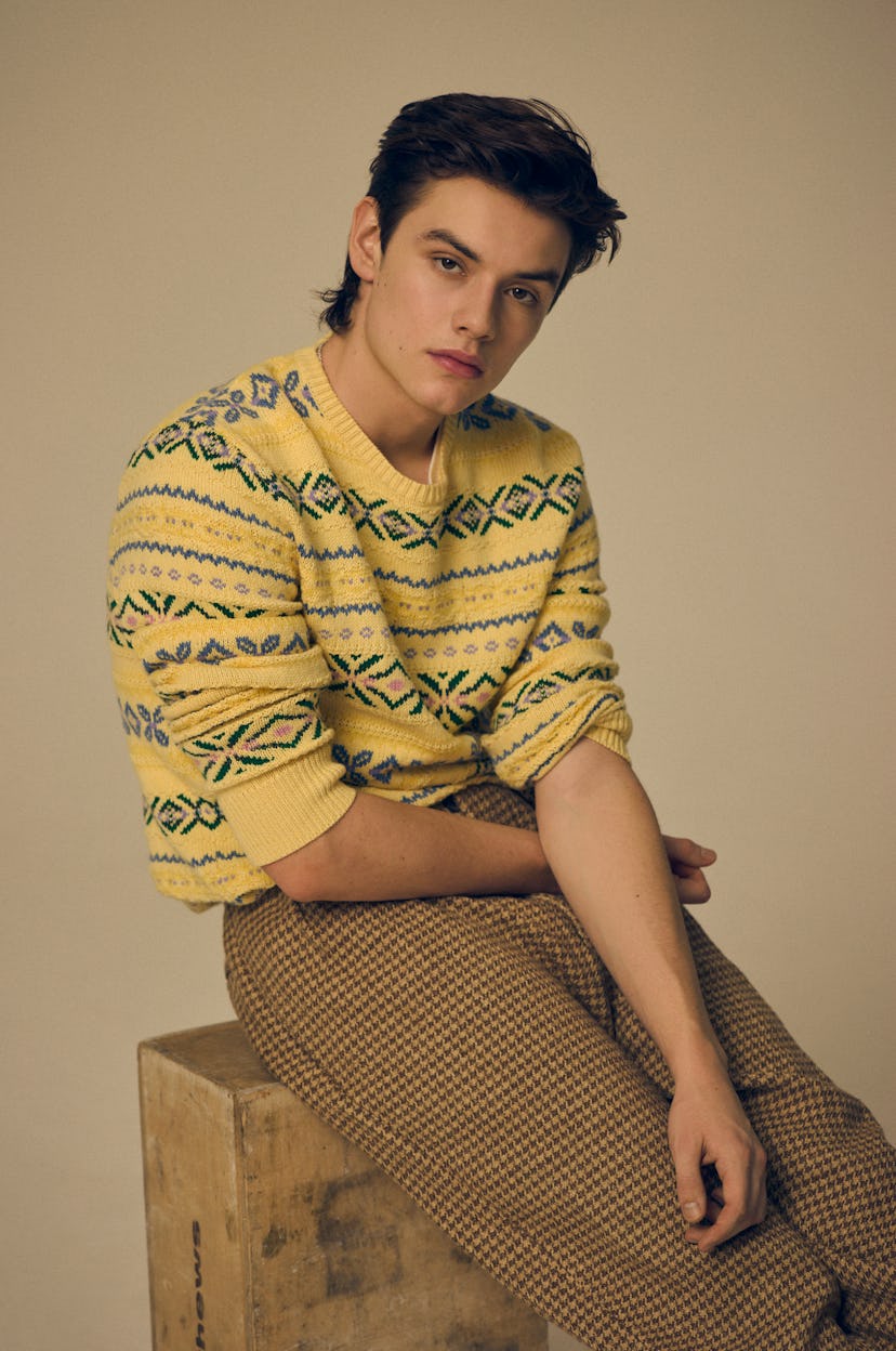 Louis Patridge wearing a yellow knit sweater