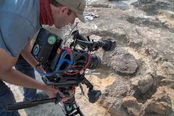 man with camcorder in a fossil bed
