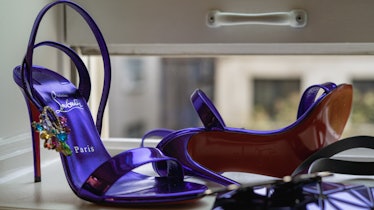 a pair of purple christian louboutin high heels