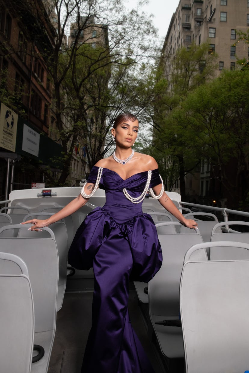 Anitta wearing purple Moschino on top of a double decker bus
