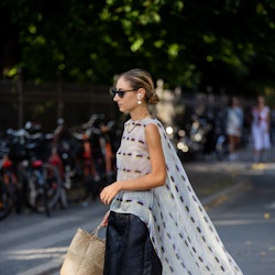 Street style star carrying a raffia bag