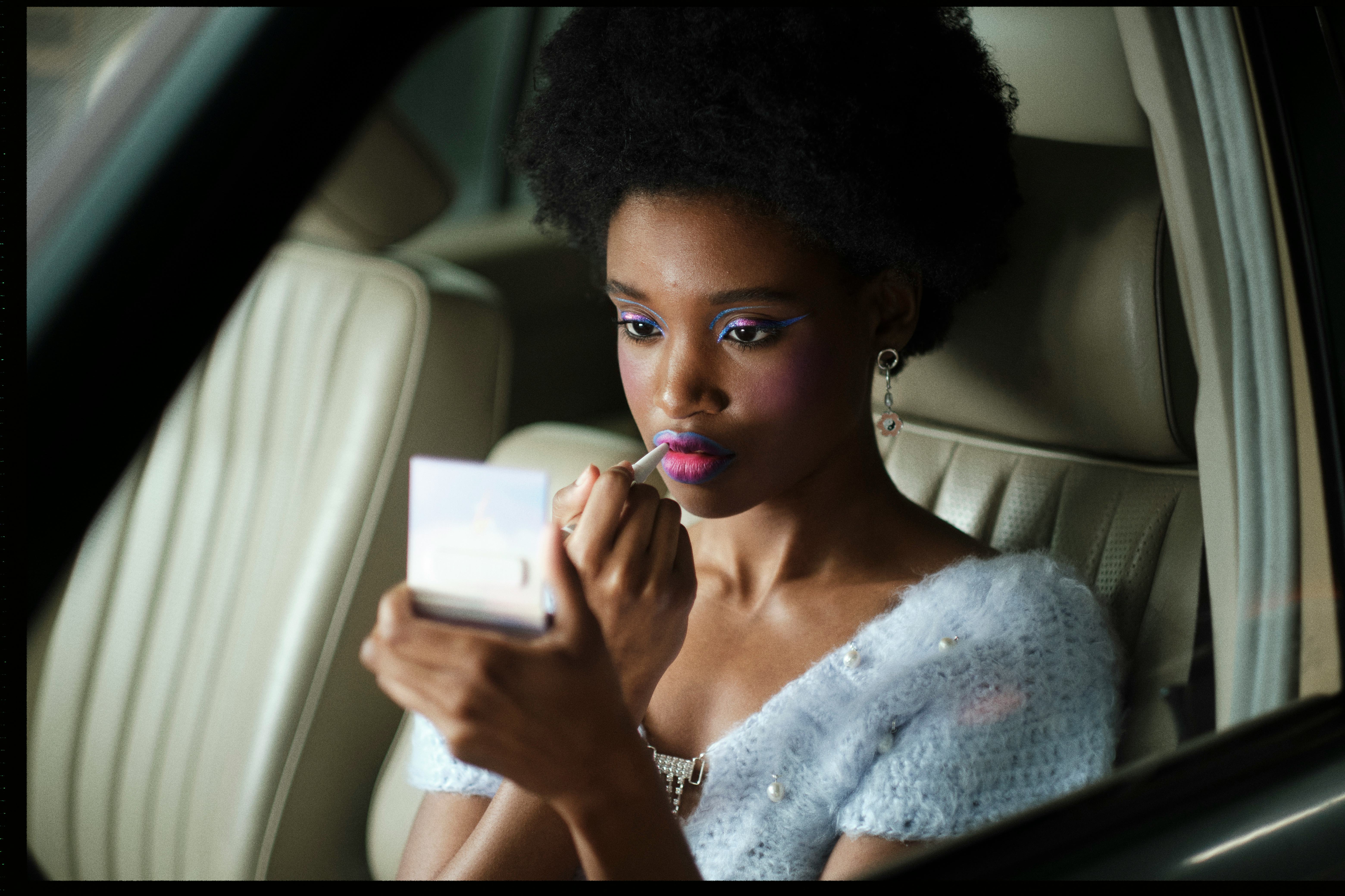 A model applies Euphoria MUA Donni Davy's Half-Magic beauty products.