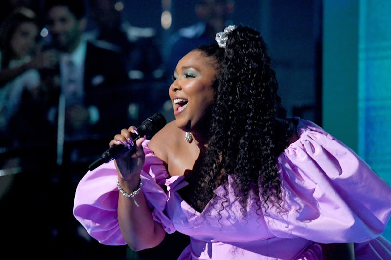 lizzo wears scrunchie and purple puff sleeved dress