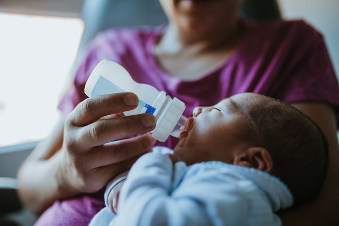 Mother feeds her newborn a bottle amid national formula shortage