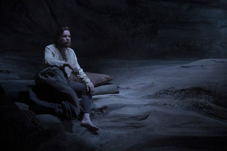 Obi-Wan Kenobi looking sad in a cave.