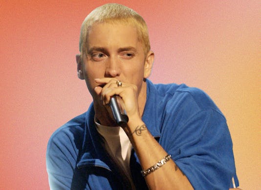 Eminem in a blue shirt and microphone performing on The Eminem Show