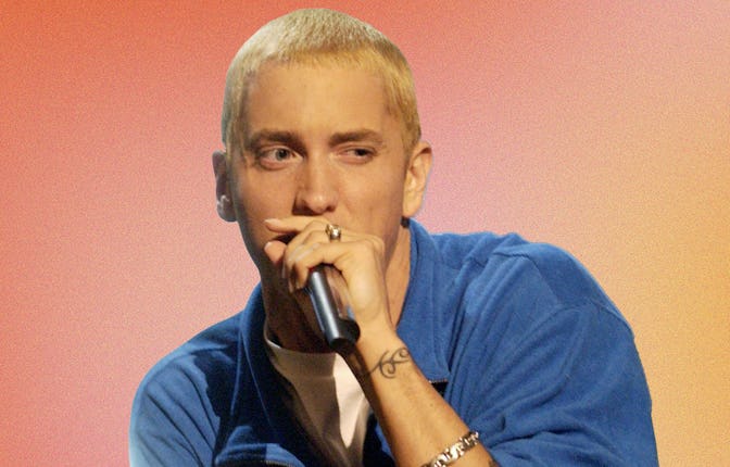 Eminem in a blue shirt and microphone performing on The Eminem Show