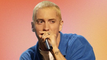 Eminem in a blue shirt and microphone performing on The Eminem Show