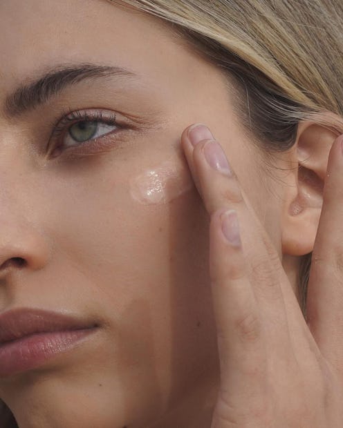 Woman applying vitamin C and niacinamide serums