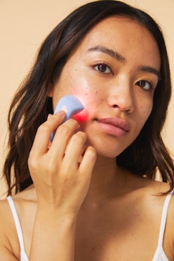 A model uses the new acne clearing device.