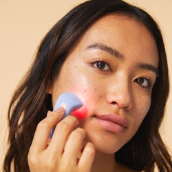 A model uses the new acne clearing device.
