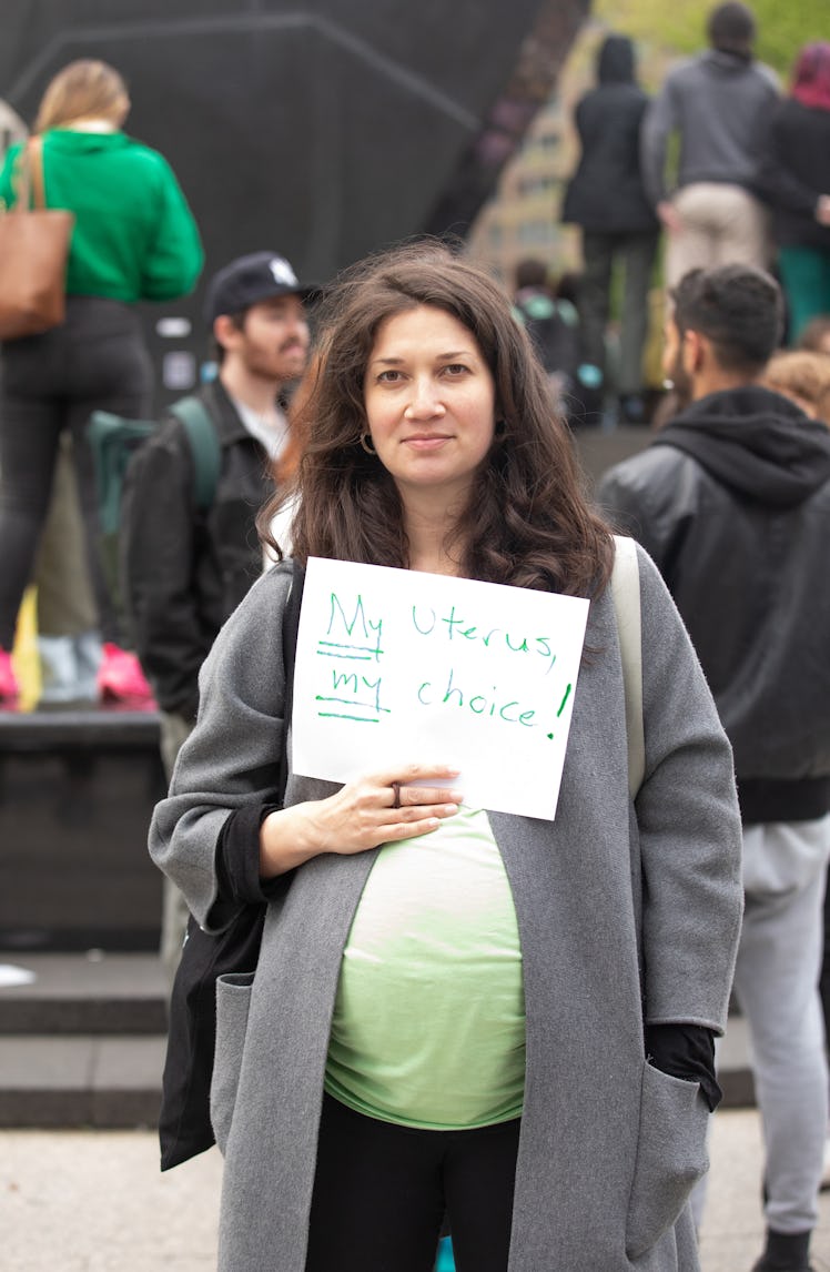 A pregnant person holding up a sign at a pro-choice protest at Foley Square in Manhattan