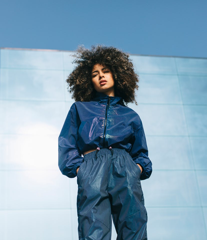 Young woman with hands in her pockets, learning about the outer planets.