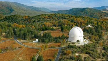 domed facility on a tree covered system of hills in california. 