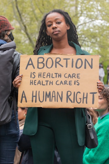 A person holding up a sign at a pro-choice protest outside Foley Square in Manhattan