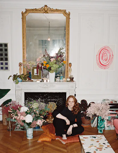 Nadège Vanhée-Cybulski sitting on the floor of a living room