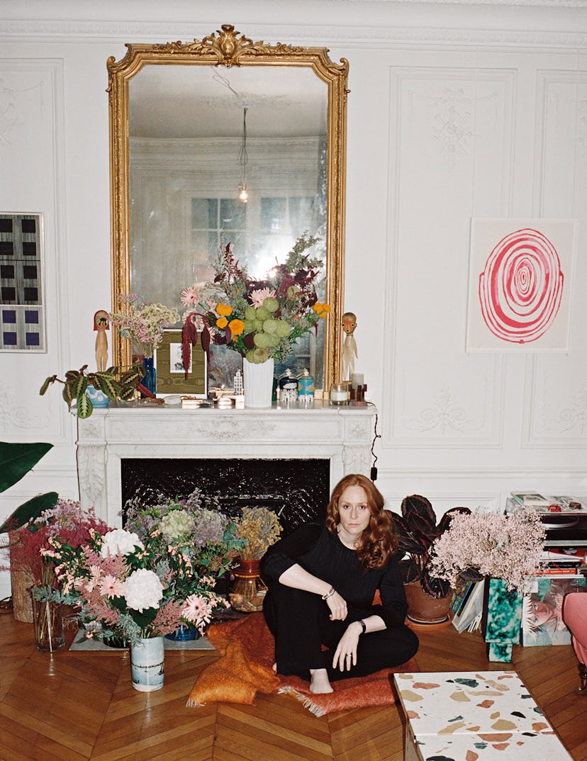 Nadège Vanhée-Cybulski sitting on the floor of a living room