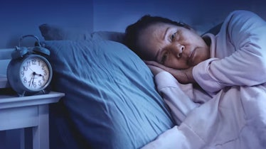 Image of an older woman being awake in the middle of the night.