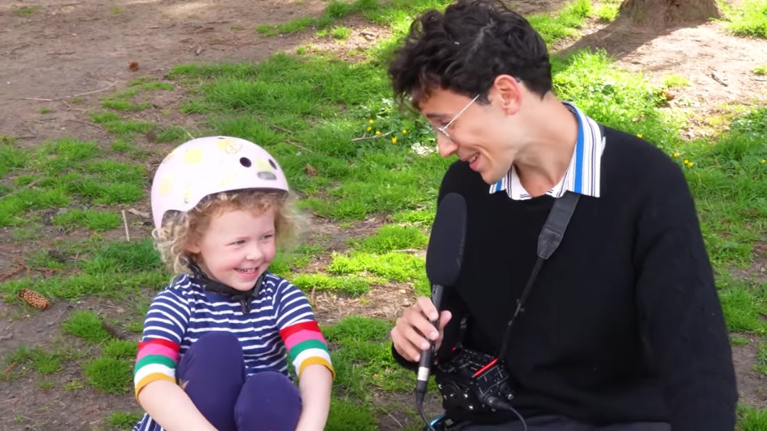 Julian Shapiro-Barnum talks to a child wearing a bicycle helmet on 'Recess Therapy.'