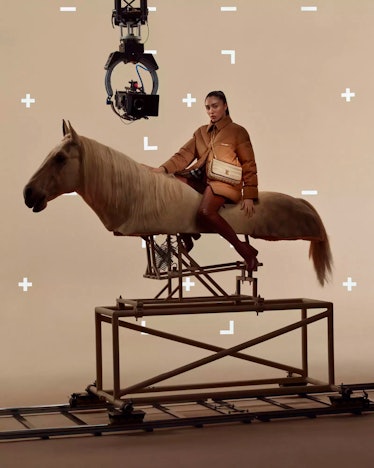 Lola Leon sitting on a mechanical horse