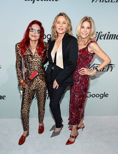 Patricia Field, Kim Cattrall, and Candace Bushnell posing on a red carpet