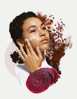 A woman putting on face cream with coffee beans behind her and slices of beets in front of her