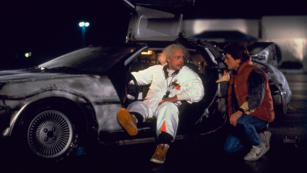 Michael J. Fox and Christopher Lloyd alongside the DeLorean in the Back to the Future franchise, whi...