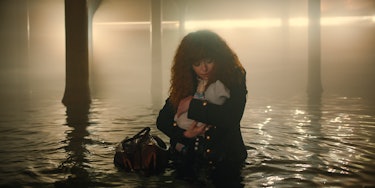 Natasha Lyonne as Nadia Vulvokov holding her baby self in episode 207 of Russian Doll. 