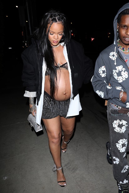 A pregnant Rihanna and ASAP Rocky hold hands as they head to Giorgio Baldi restaurant for her baby s...