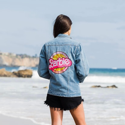 The Barbie Truck Tour is back with Malibu Barbie-inspired merch like a jean jacket. 