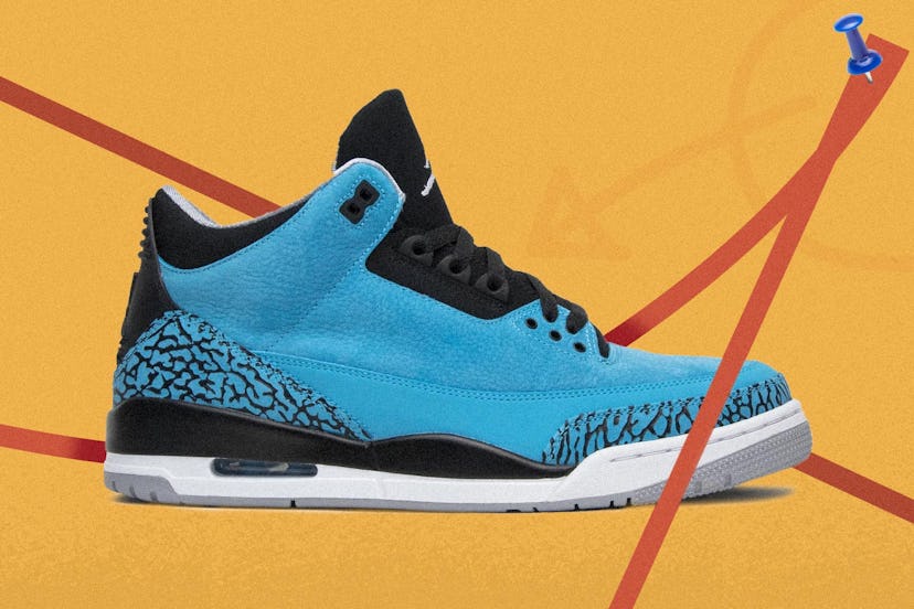 Blue air jordan sneakers in front of a yellow background with red tape circling them