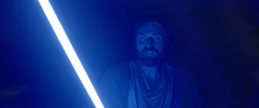 Ewan McGregor holds up his blue lightsaber in Obi-Wan Kenobi Episode 3