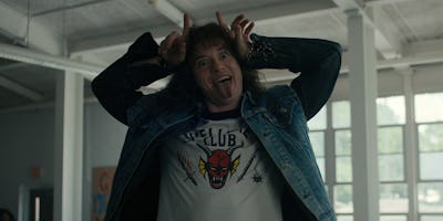 Eddie Munson (Joseph Quinn) from Stranger Things making a silly face while wearing a white Hellfire ...
