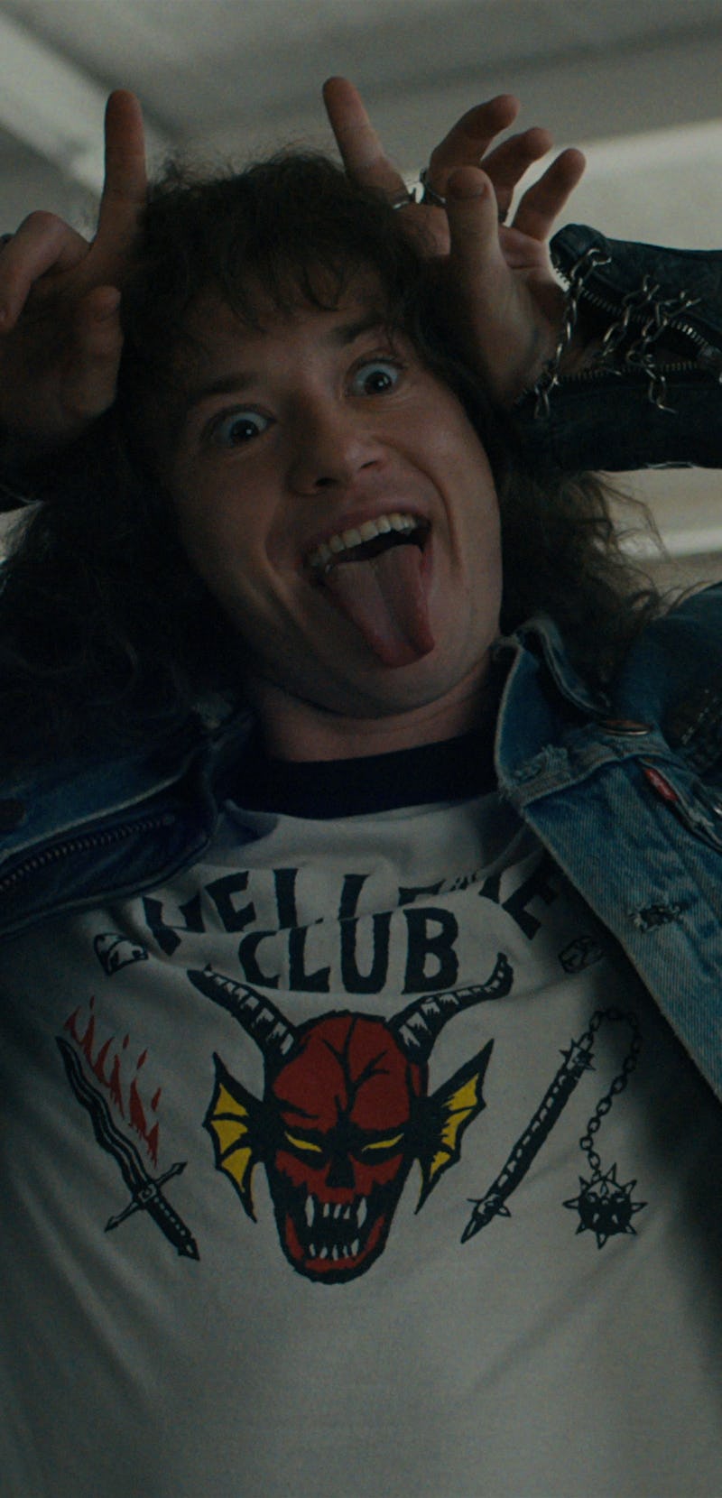 Eddie Munson (Joseph Quinn) from Stranger Things making a silly face while wearing a white Hellfire ...
