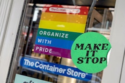 "Organize with Pride" sign in pride colors as an ad on the door of a container store, mocking corpor...